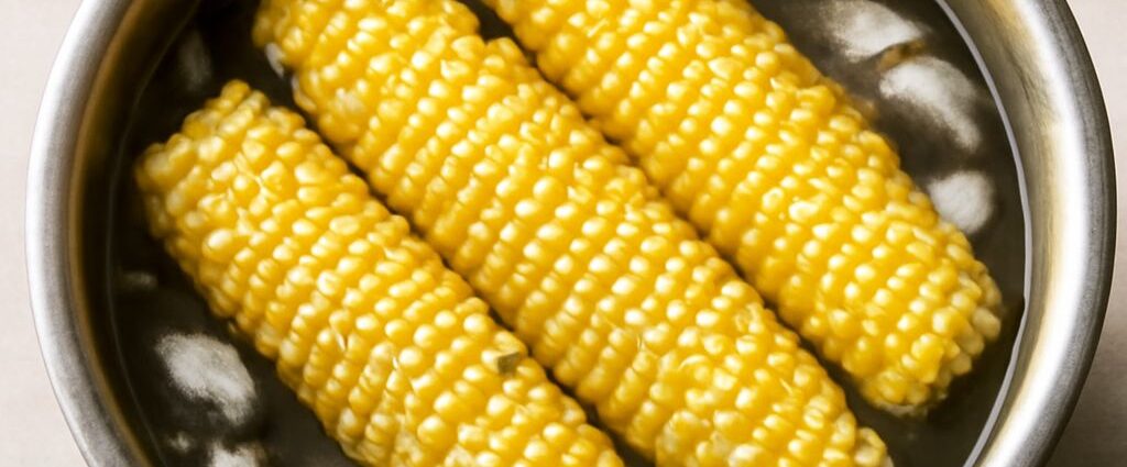 Corn being blanched in boiling water before freezing