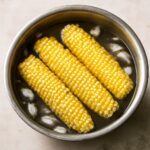 Corn being blanched in boiling water before freezing