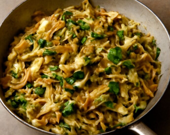 Seasoned cabbage cooked in a skillet on the stove