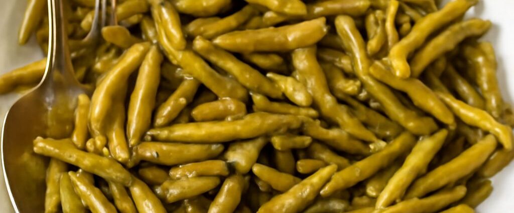 Seasoned canned green beans in a serving bowl