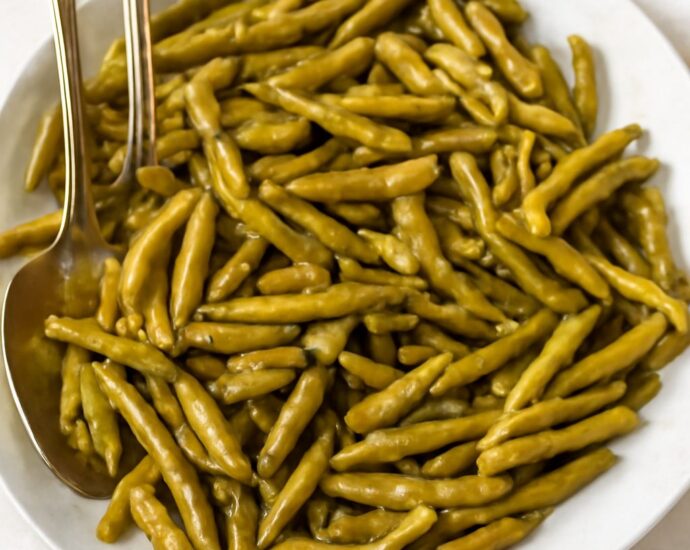 Seasoned canned green beans in a serving bowl