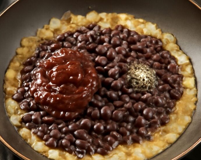 Chipotle black beans recipe served in a bowl with smoky sauce and herbs