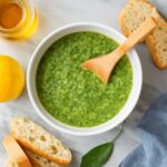 Bowl of dairy free pesto with basil, nuts, lemon, and garlic