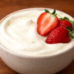Dairy free whipped topping in a bowl with soft peaks