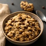 Eggless chocolate chip cookies stacked on a cooling rack