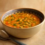 A pot of cooked great Northern beans simmering on the stove