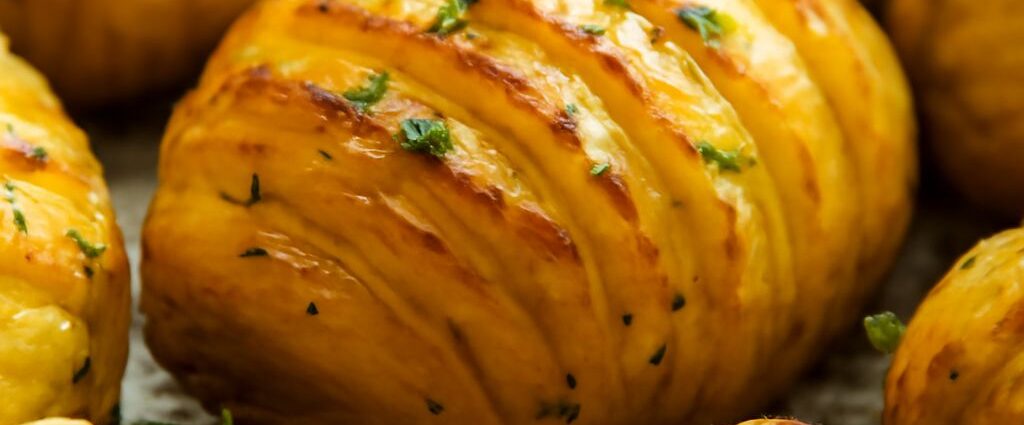 Bowl of herb roasted potatoes with crisp edges and fresh herbs