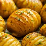 Bowl of herb roasted potatoes with crisp edges and fresh herbs