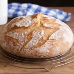 Homemade potato bread recipe with sliced loaf and fresh potatoes