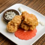 Crispy maitake mushroom clusters browned in a pan