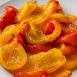 A tray of delicious oven roasted bell peppers showing how to roast peppers in oven settings.
