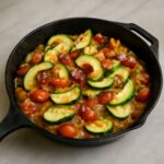 Pan fried zucchini slices browned in a skillet