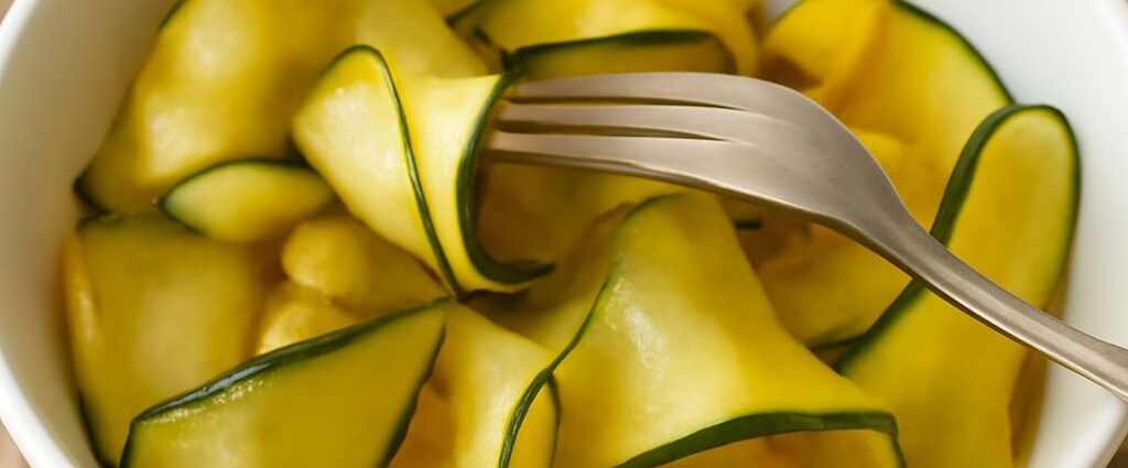 Jar of quick pickled zucchini with herbs and sliced zucchini