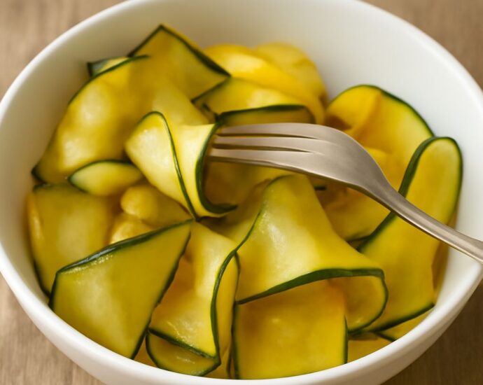 Jar of quick pickled zucchini with herbs and sliced zucchini