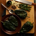 Freshly roasted poblano peppers (K1) ready for cooking poblano peppers (K3) in recipes.