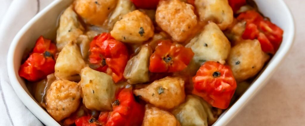 Roasted potatoes and onions on a baking sheet