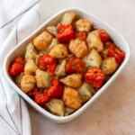 Roasted potatoes and onions on a baking sheet