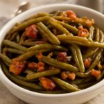 Slow cooker green beans in a crock pot with seasoning