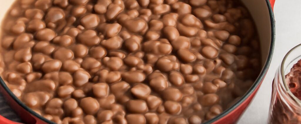 Dry pinto beans soaking in water in a bowl