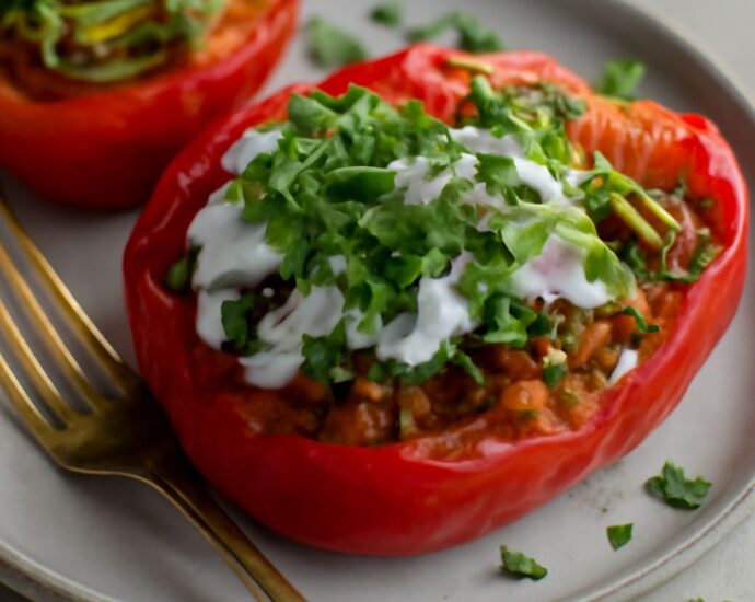 Taco stuffed peppers filled with seasoned vegetables and rice