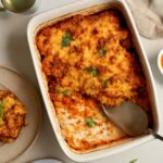 A baked vegan casserole served in a dish with vegetables and grains