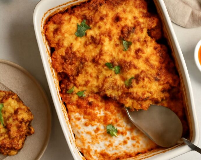 A baked vegan casserole served in a dish with vegetables and grains