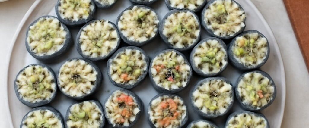 Vegan sushi rolls with rice, nori, avocado, cucumber, and carrots