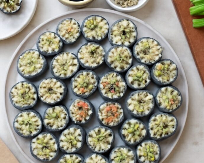 Vegan sushi rolls with rice, nori, avocado, cucumber, and carrots
