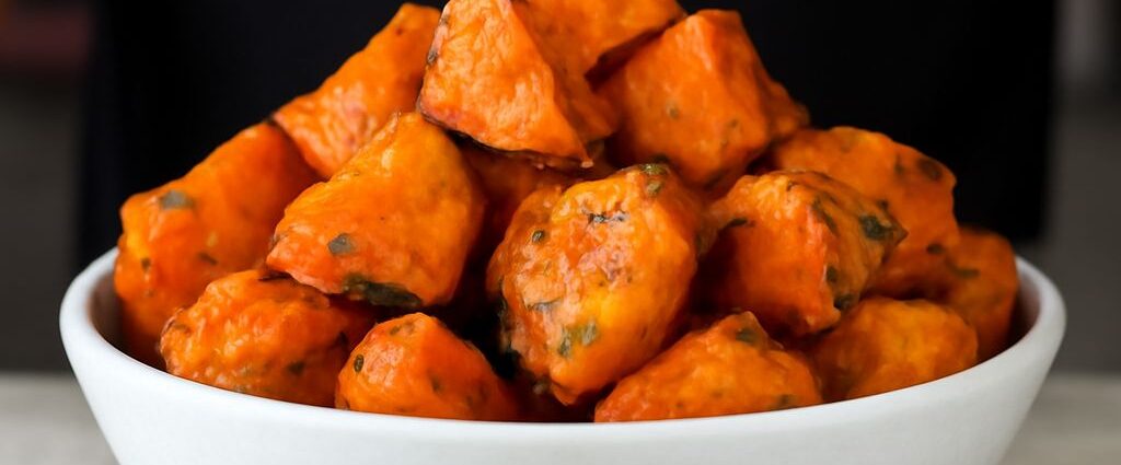 Roasted white sweet potatoes on a baking tray