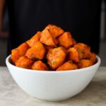 Roasted white sweet potatoes on a baking tray