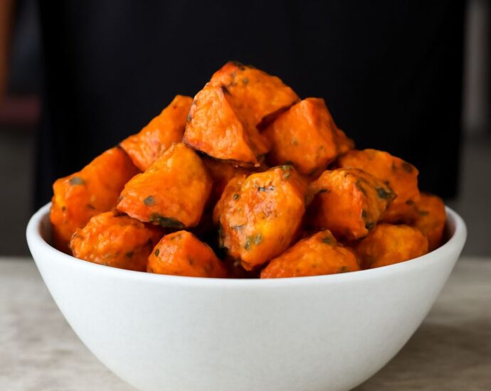 Roasted white sweet potatoes on a baking tray