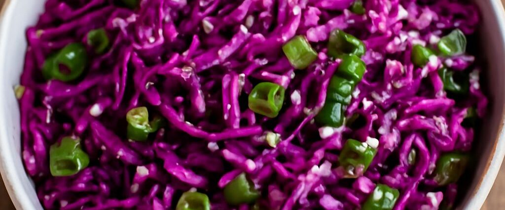 Oriental cabbage salad with sesame-ginger dressing, shredded cabbage, carrots, scallions, and peanuts