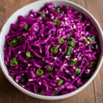 Oriental cabbage salad with sesame-ginger dressing, shredded cabbage, carrots, scallions, and peanuts