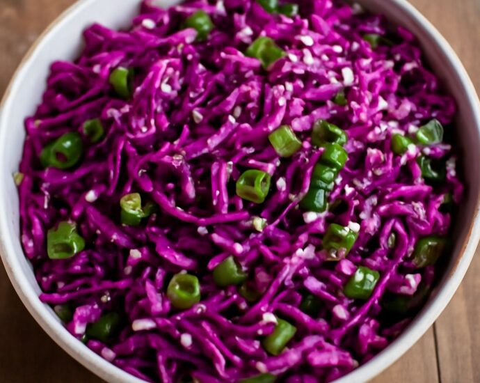 Oriental cabbage salad with sesame-ginger dressing, shredded cabbage, carrots, scallions, and peanuts