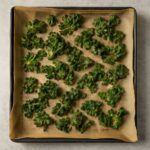 Baked kale chips beside tender roasted kale