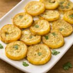 Baked yellow squash recipe in an 8-inch dish with a browned savory breadcrumb topping