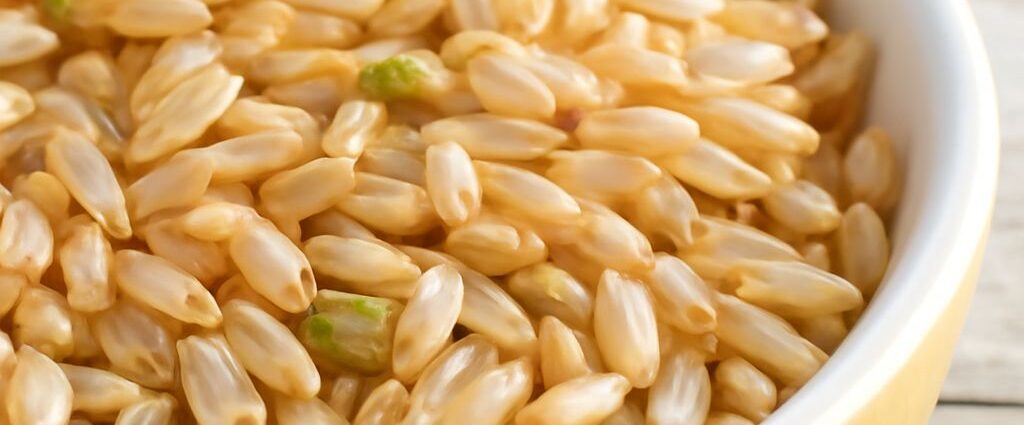 Dry brown rice in an airtight glass container with a freshness label
