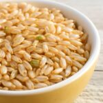 Dry brown rice in an airtight glass container with a freshness label