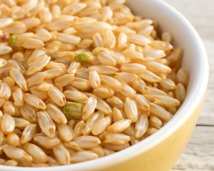 Dry brown rice in an airtight glass container with a freshness label