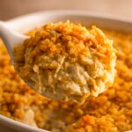 Cheesy potato casserole with a crisp corn-flake topping in a baking dish