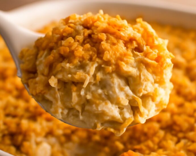 Cheesy potato casserole with a crisp corn-flake topping in a baking dish