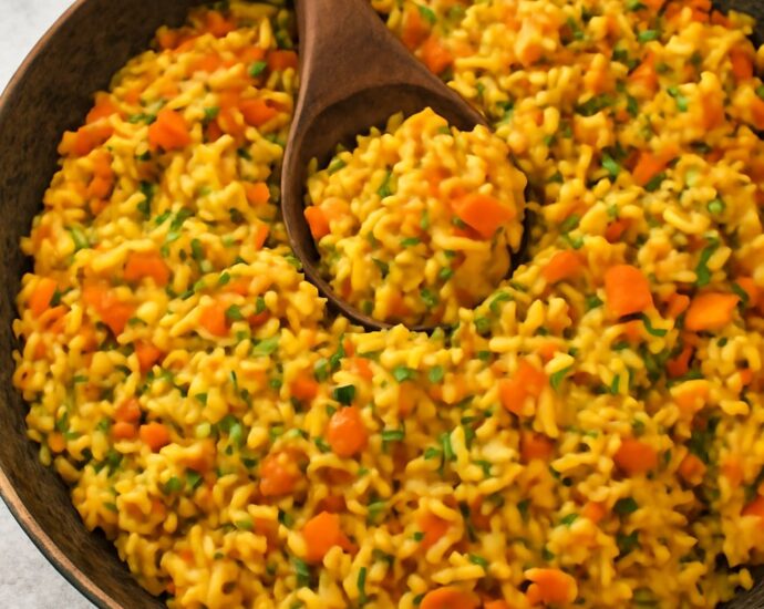 A bowl of fluffy basmati rice colored golden by bloomed spices