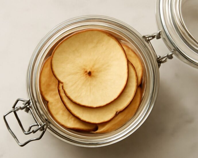 Apple slices drying on a dehydrator tray until chewy or crisp