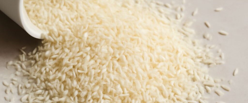 Uncooked white and brown rice stored in sealed containers