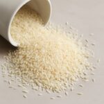 Uncooked white and brown rice stored in sealed containers