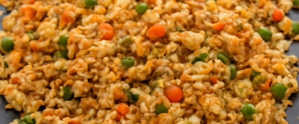 Fried rice made gluten-free with tamari, egg, peas, carrots, and scallions