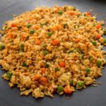 Fried rice made gluten-free with tamari, egg, peas, carrots, and scallions