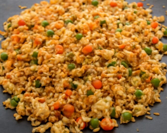 Fried rice made gluten-free with tamari, egg, peas, carrots, and scallions