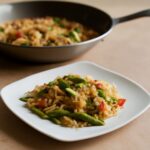 Healthy fried rice with vegetables, egg, and tofu in a bowl