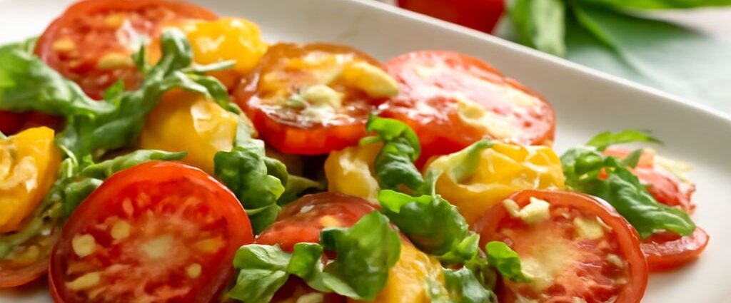 Colorful heirloom tomatoes with basil, toast, and roasted tomato slices